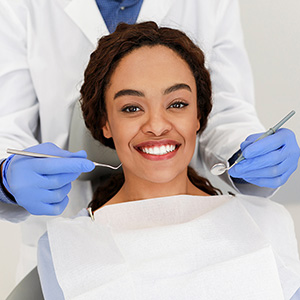 Woman on a Dental Chair Flashing Her Smile | Dental Services